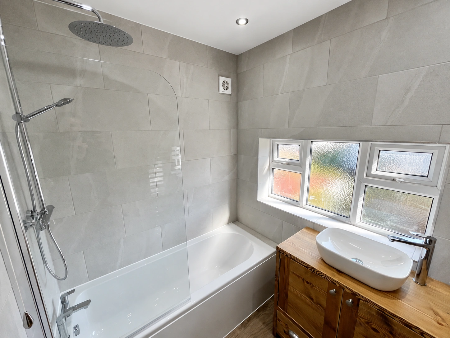 Completed grey bath and shower installation in Leeds