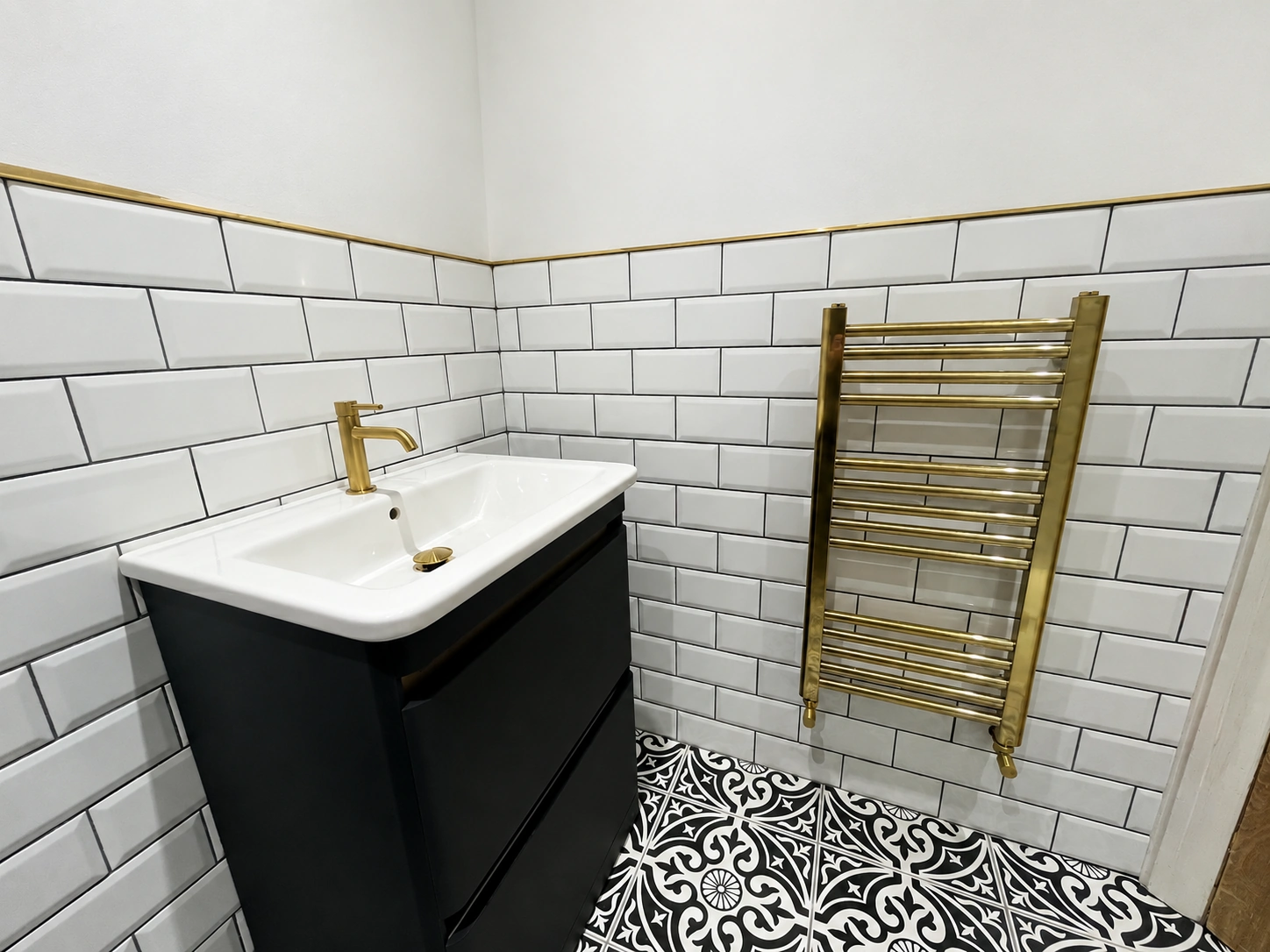 Completed bathroom with vanity and brass radiator in Leeds